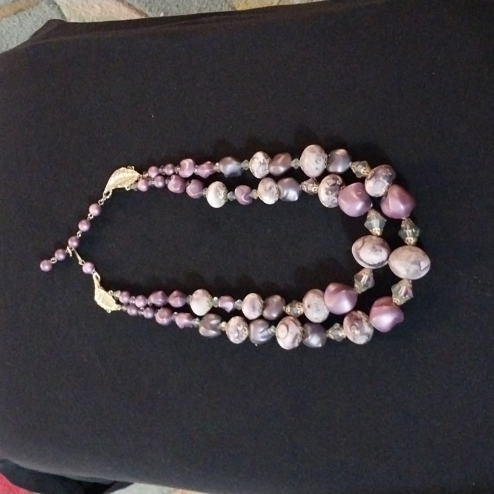 Antique Purple Beads offset with crystal beads.